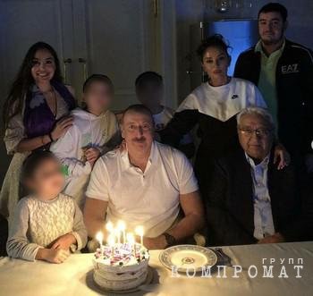 Arif Pashayev sits to the right of Ilham Aliyev surrounded by family members