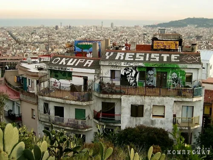 Illegally occupied building in Barcelona.  On the roof there is an inscription: “Occupy and resist!”