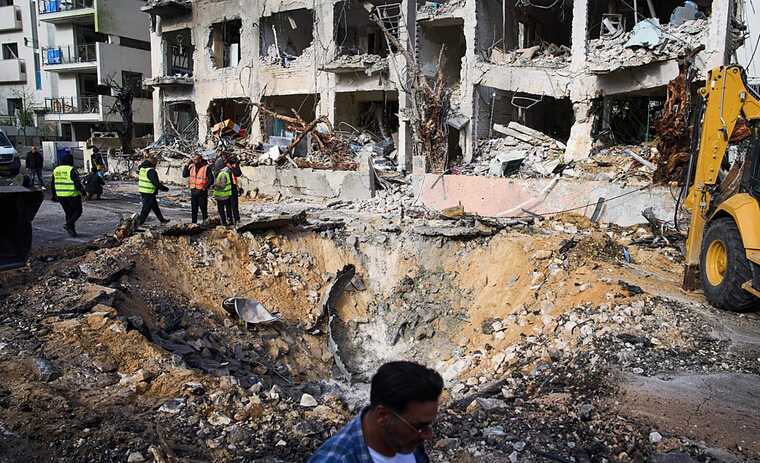 Tel Aviv residents assess the damage after Iranian missile strikes